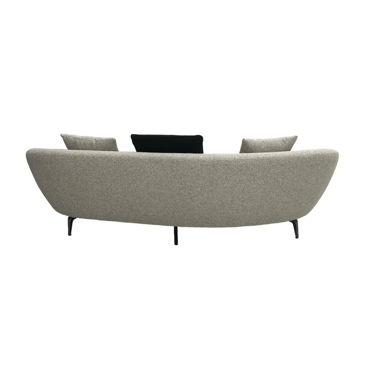 curved back couch with throw pillows